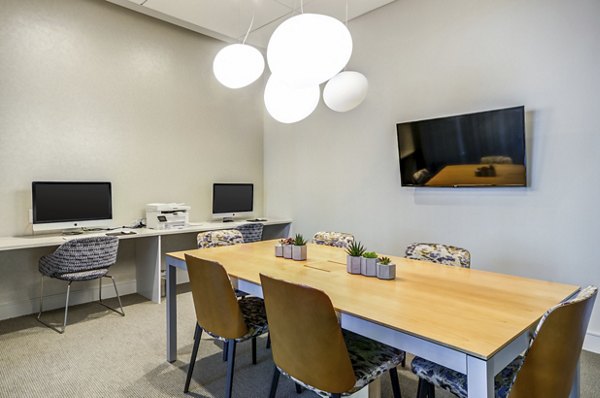 Modern business center with sleek workstations at Loren Apartments, ideal for productivity and collaboration