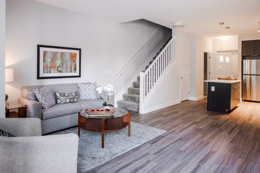 Spacious living room with modern decor and large windows at Loren Apartments