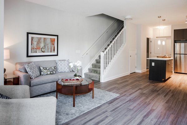 Spacious living room with modern decor and large windows at Loren Apartments