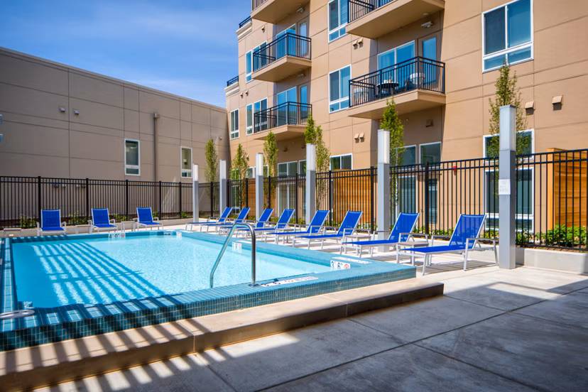Resort-style pool with lounge chairs at Loren Apartments