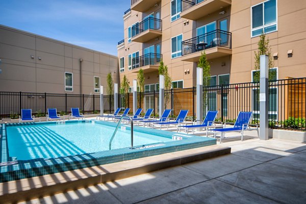 Resort-style pool with lounge chairs at Loren Apartments