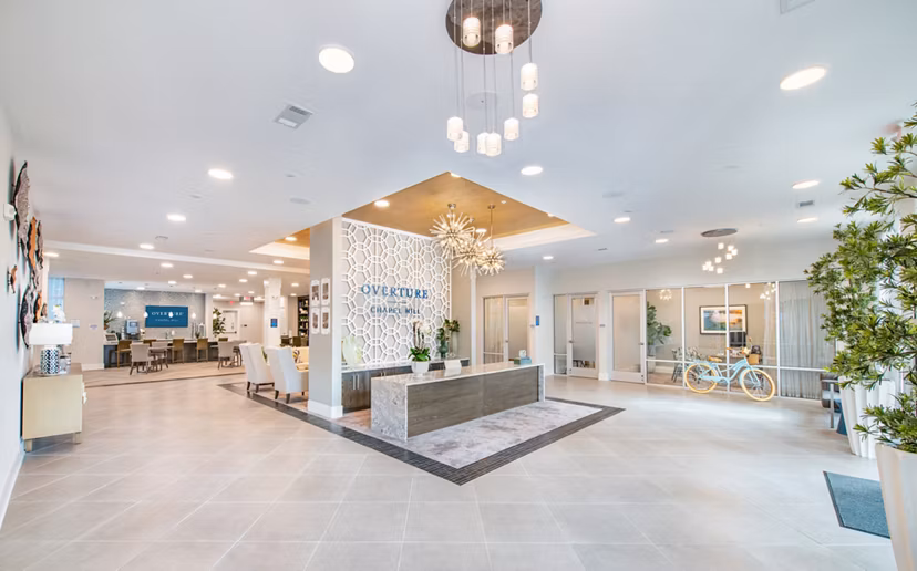 Clubhouse with modern decor and cozy seating at Overture Chapel Hill Apartments for a luxury living experience