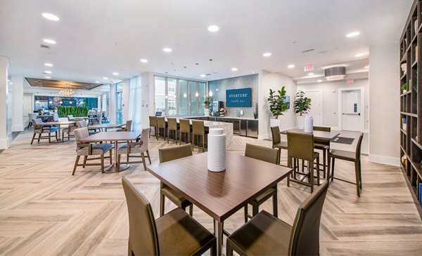 Clubhouse with modern furnishings and open seating area at Overture Chapel Hill Apartments Luxury community