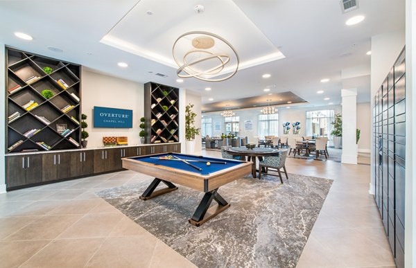 Game room with pool table and lounge seating at Overture Chapel Hill Apartments, a luxury community offering vibrant social spaces