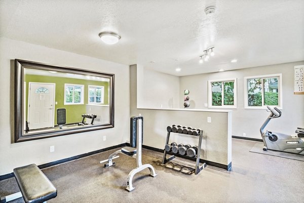 Modern fitness center equipped with cardio and weight machines at Kendall Ridge Apartments