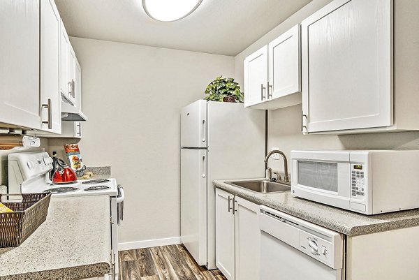 Kendall Ridge Apartments: Contemporary kitchen with stainless steel appliances and granite countertops