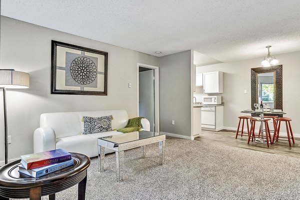 Modern living room with stylish decor and large windows at Kendall Ridge Apartments