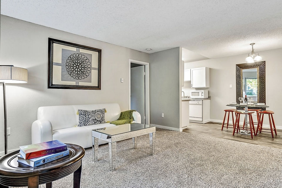 Modern living room with stylish decor and large windows at Kendall Ridge Apartments