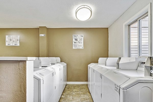 Laundry room equipped with modern washers and dryers at Kendall Ridge Apartments