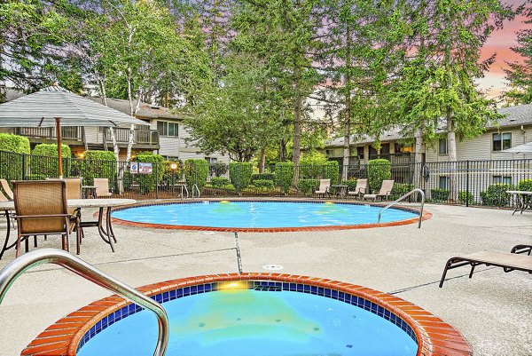 Expansive outdoor pool at Kendall Ridge Apartments with poolside lounging and lush landscaping