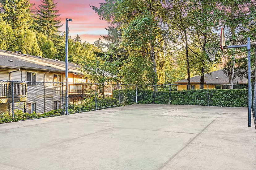 Sport court at Kendall Ridge Apartments: Outdoor recreation area featuring tennis and basketball courts