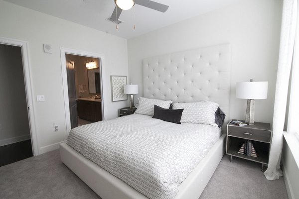 Cozy bedroom with modern furnishings at Amorance Apartments, showcasing luxurious living in a prime location