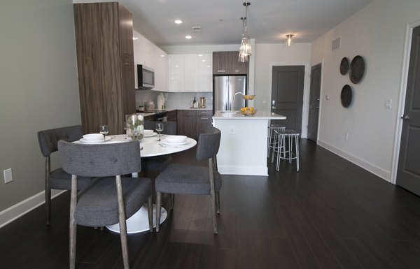 Dining area featuring elegant seating and modern lighting in Amorance Apartments, a luxury property