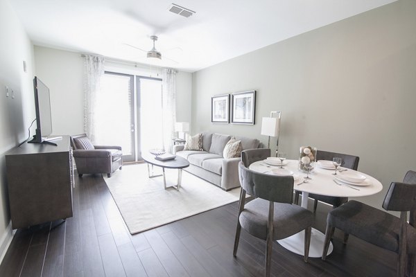 Modern living room with elegant decor at Amorance Apartments, featuring stylish furniture and abundant natural light