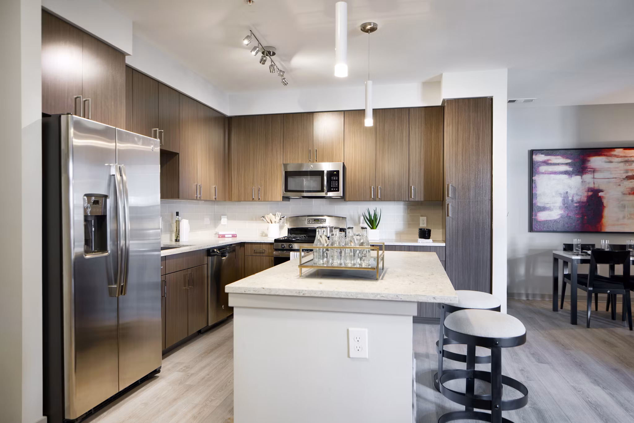 Modern kitchen with sleek cabinetry and stainless steel appliances in Indigo 301 Apartments