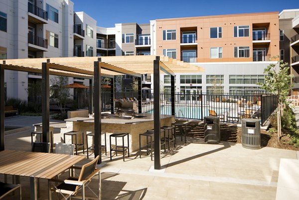 Outdoor BBQ grill area at Indigo 301: luxury apartment community offering residential conveniences