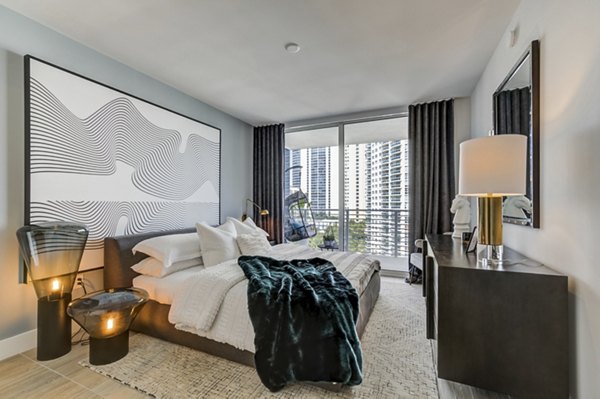 Spacious bedroom with modern decor at Alluvion Las Olas Apartments Perfect blend of comfort and style for luxury living in Fort Lauderdale