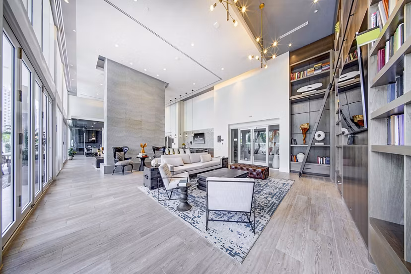 Modern clubhouse with cozy seating and entertainment areas at Alluvion Las Olas Apartments