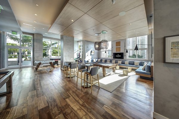Modern clubhouse with contemporary furnishings at Alluvion Las Olas Apartments, ideal for social gatherings and events