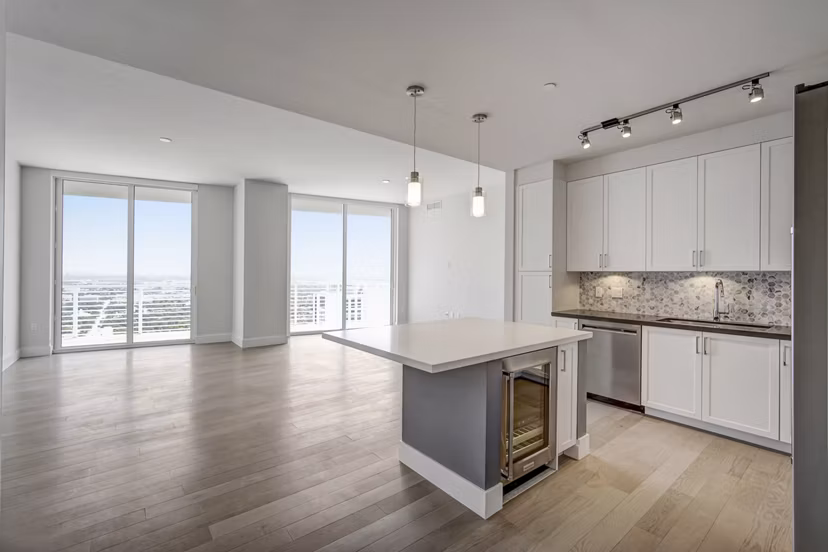 Modern kitchen with sleek countertops and stainless steel appliances at Alluvion Las Olas Apartments