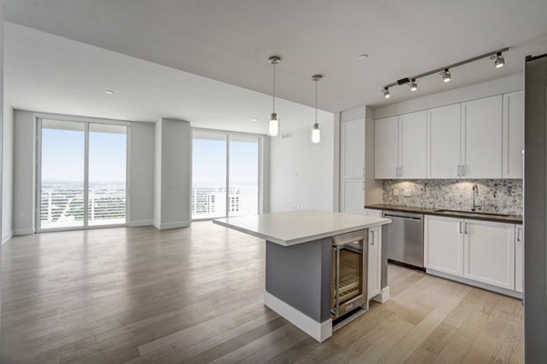 Modern kitchen with sleek countertops and stainless steel appliances at Alluvion Las Olas Apartments