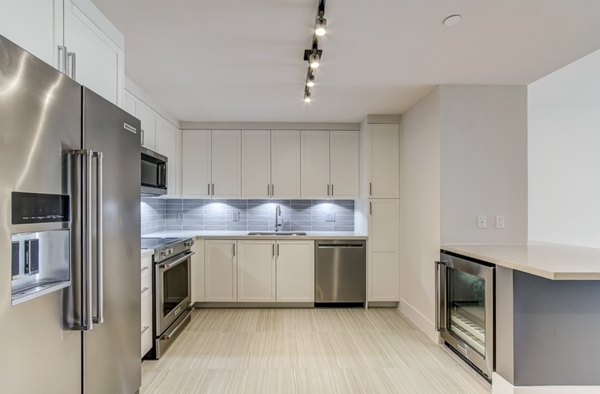 Modern kitchen with stainless steel appliances at Alluvion Las Olas Apartments