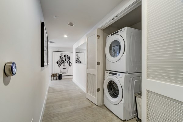 Modern laundry room with high-efficiency washers and dryers at Drexler Townhomes in Holbrook Farms
