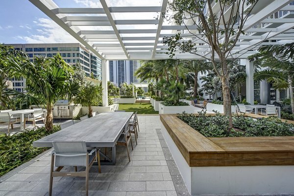 Tranquil courtyard with lush landscaping at Alluvion Las Olas Apartments in Fort Lauderdale