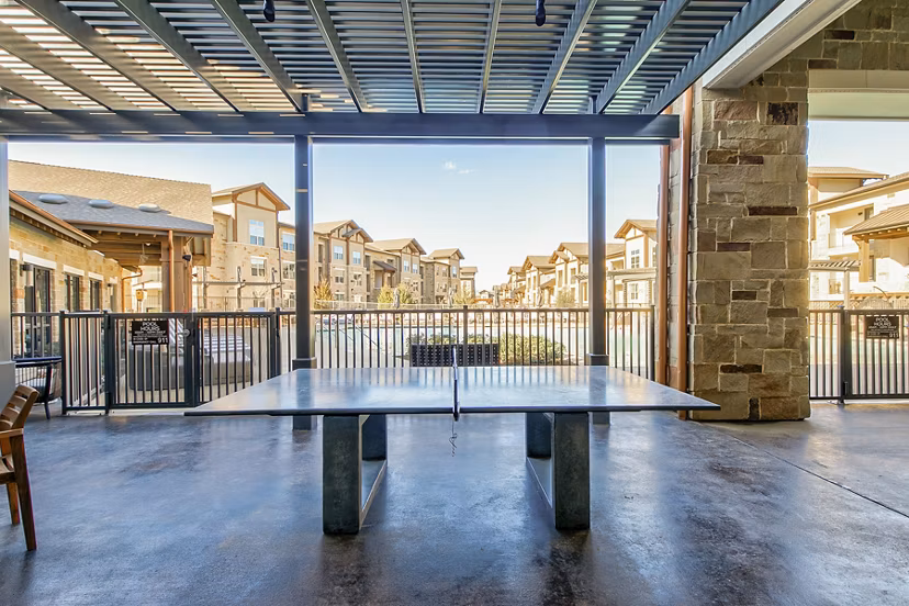 Modern game room with pool table and arcade games at The Preserve luxury apartments