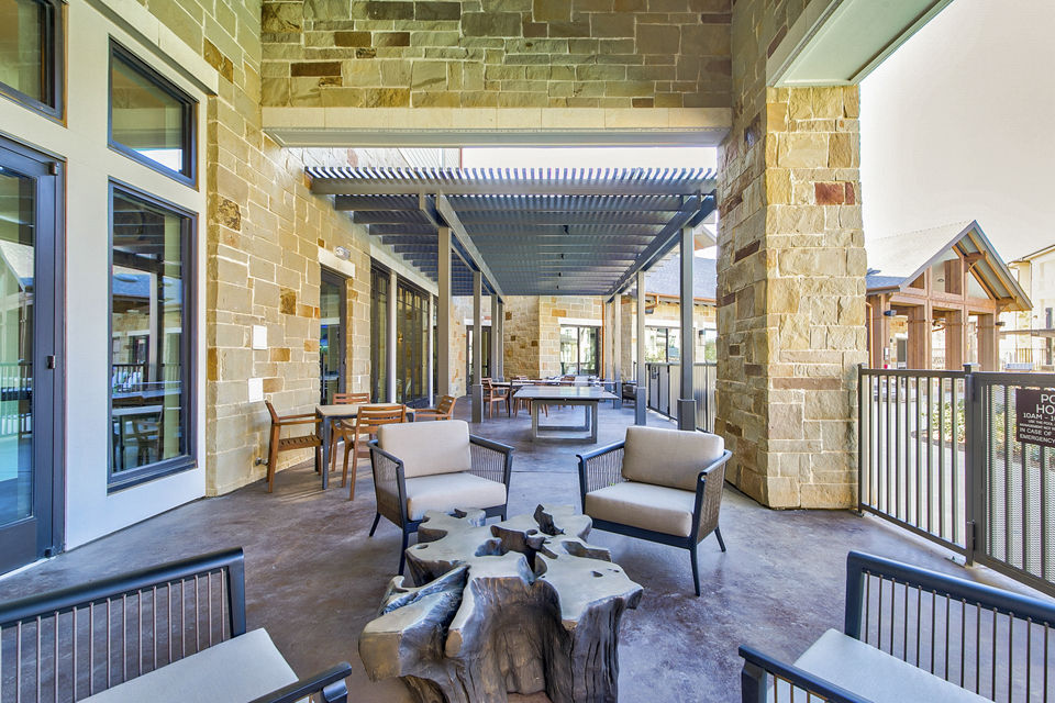 Patio with stylish seating and garden views at The Preserve luxury apartments