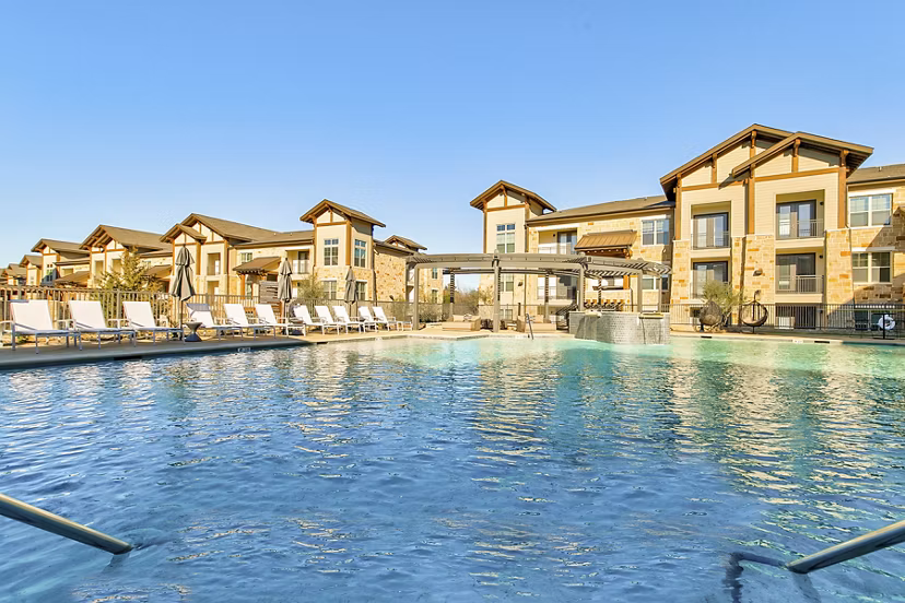 Outdoor swimming pool with lounge chairs at The Preserve, luxury apartments