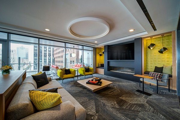 Clubhouse featuring modern furnishings and open space at 511 Faye Apartments
