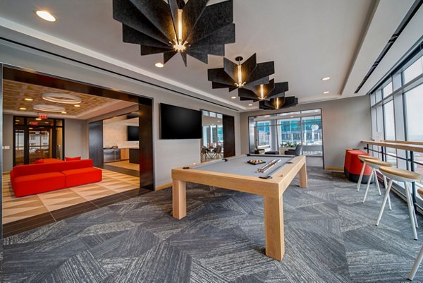 Game room with billiards table and lounge seating at 511 Faye Apartments