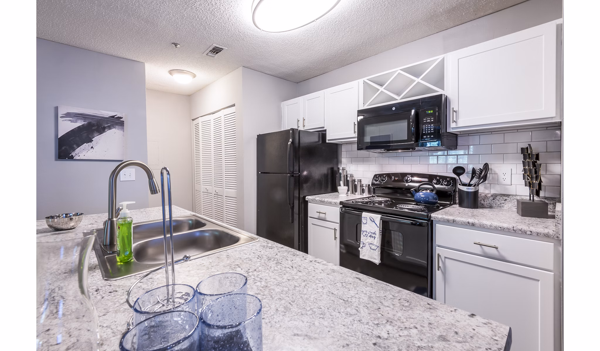Modern kitchen with stainless steel appliances at Bridgeport Apartments luxury community