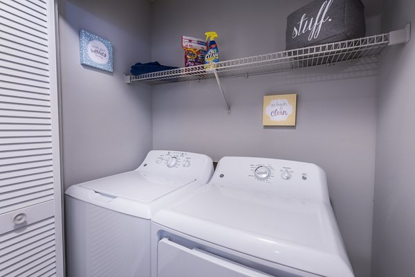 Laundry room with modern appliances in Bridgeport Apartments for convenient living