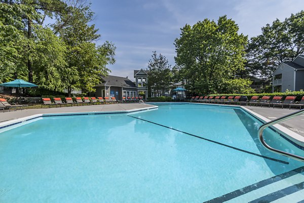 Resort-style pool with lounge chairs at Bridgeport Apartments offering luxury living experiences