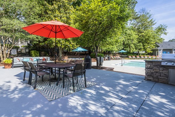 Outdoor grill area with modern seating at Bridgeport Apartments, the perfect entertaining space in a luxury community