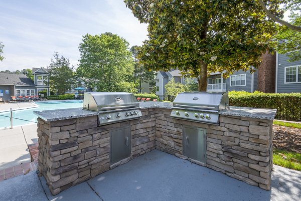 Outdoor dining area with BBQ grills at Bridgeport Apartments offering a luxurious lifestyle experience