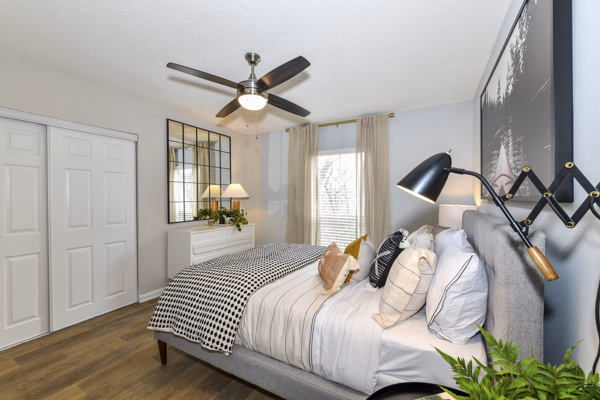 Cozy bedroom with stylish decor at Avana Cumberland Apartments, offering luxury living in a serene setting