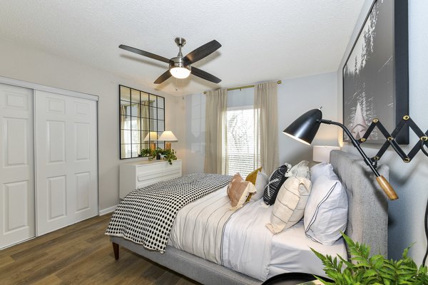Cozy bedroom with stylish decor at Avana Cumberland Apartments, offering luxury living in a serene setting