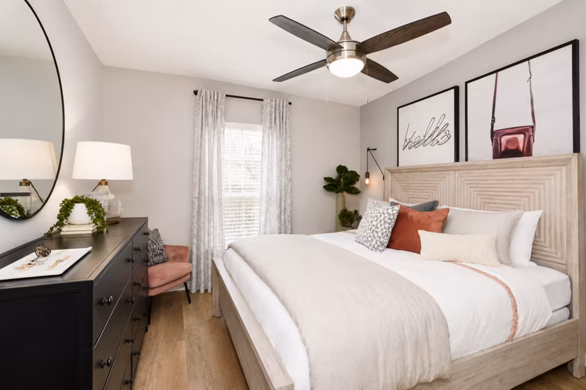 Modern bedroom with sleek furniture and plush bedding at Avana Cumberland Apartments