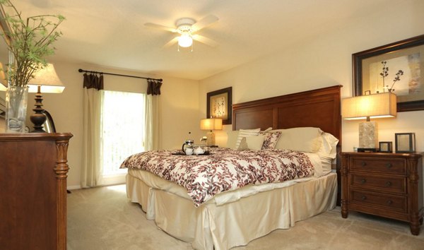 Modern bedroom with serene color palette at Avana Cumberland Apartments, featuring large windows and stylish decor for luxury living