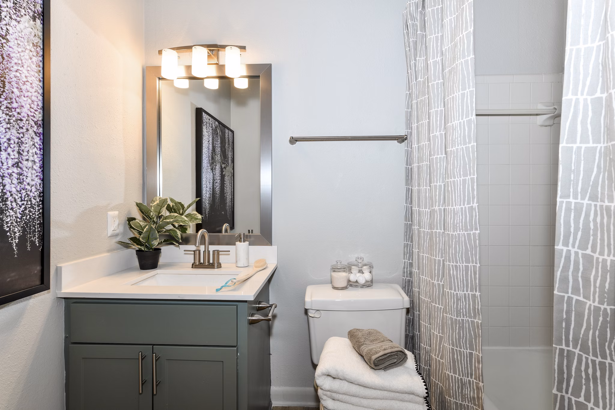 Bathroom featuring modern fixtures and granite countertops at Avana Cumberland Apartments