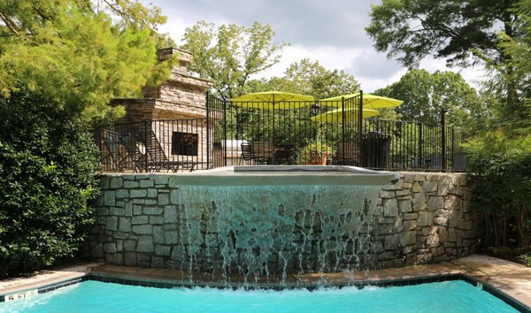 Inviting pool area at Avana Cumberland Apartments with lounge chairs and vibrant landscaping, ideal for relaxation and social gatherings