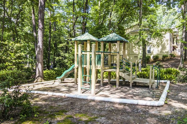 Spacious playground with slides and swings at Avana Cumberland Apartments, ideal for family fun and outdoor activities