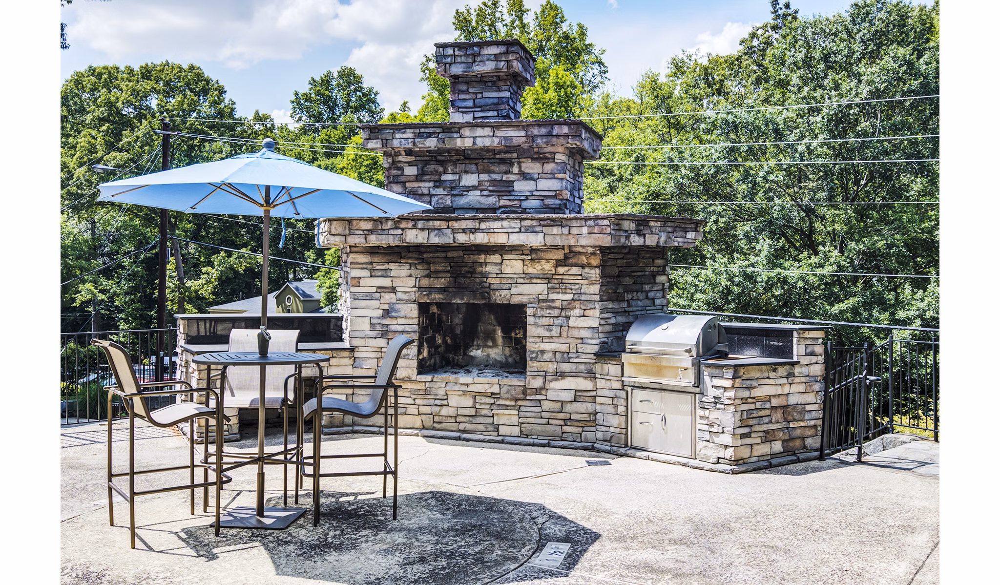 Outdoor grill area with seating at Avana Cumberland Apartments, perfect for gatherings and barbecues