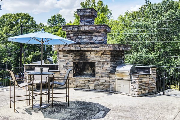 Outdoor grill area with seating at Avana Cumberland Apartments, perfect for gatherings and barbecues