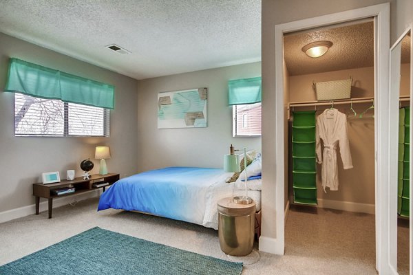 Cozy bedroom with elegant decor in Tuscan Heights Apartments, showcasing luxury living in the Greystar community