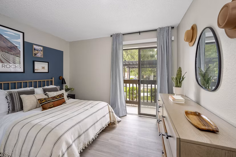 Cozy bedroom with modern decor and natural lighting at Tuscan Heights Apartments