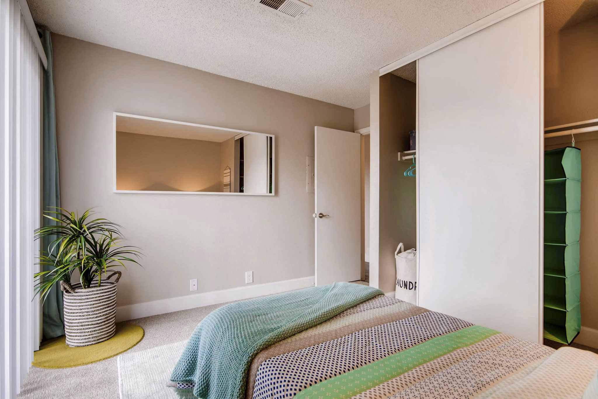 Tuscan Heights Apartments: Elegant bedroom with designer furniture and soft lighting for luxurious living